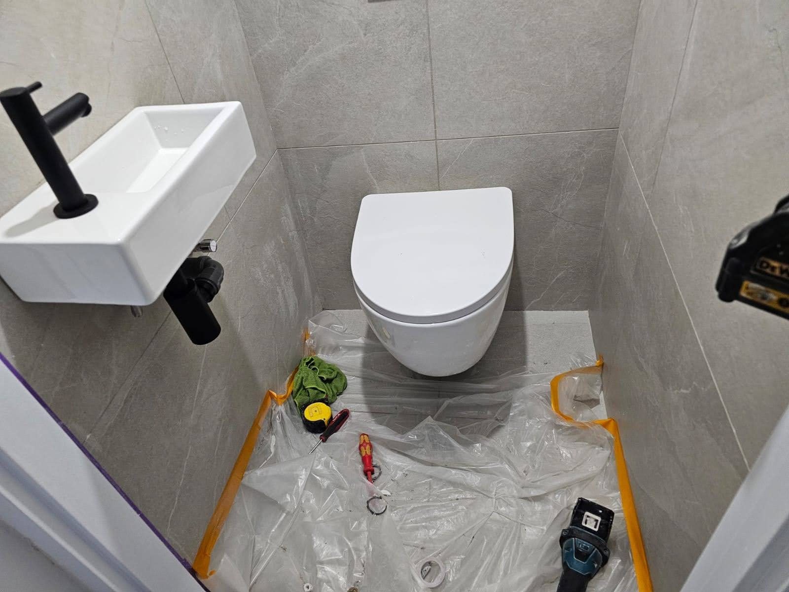 Complete bathroom renovation from scratch - plumbing connections, floor & wall tiling, full fixture installation: shower cabin, toilet and concealed cistern